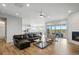Inviting living room with a cozy fireplace and seamless flow to the outdoor patio at 18212 W 95Th Pl, Arvada, CO 80007