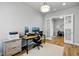 Bright office space with hardwood flooring, neutral walls, and natural light at 18212 W 95Th Pl, Arvada, CO 80007