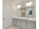 Bathroom featuring double sink vanity, modern lighting, and a large mirror at 1818 Sawtooth Mountain Dr, Berthoud, CO 80513