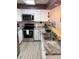 Well-lit kitchen with stainless steel appliances, white cabinets, and durable counter tops at 8224 Washington St # 11, Denver, CO 80229