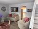 Comfortable living room featuring a cozy sofa, chair and an open view to the kitchen at 8224 Washington St # 11, Denver, CO 80229