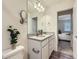 Well-lit bathroom with double sinks, granite countertops, and modern fixtures at 12920 Jasmine St # F, Thornton, CO 80602