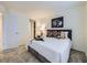 Bedroom featuring a comfortable queen size bed, large window, and horse artwork at 12920 Jasmine St # F, Thornton, CO 80602
