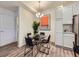 Chic dining area with modern chandelier, round glass table, and unique decor at 12920 Jasmine St # F, Thornton, CO 80602