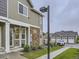 Well-maintained townhome exterior featuring stone accents and a manicured lawn at 12920 Jasmine St # F, Thornton, CO 80602