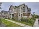 Attractive townhome featuring stone accents, well-manicured lawn, and inviting curb appeal at 12920 Jasmine St # F, Thornton, CO 80602