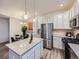 Well-equipped kitchen with stainless steel appliances, granite countertops, and a dining area nearby at 12920 Jasmine St # F, Thornton, CO 80602