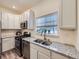 Updated kitchen featuring granite countertops and stainless steel appliances at 12920 Jasmine St # F, Thornton, CO 80602