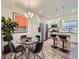 Bright kitchen features stainless steel appliances, granite countertops, island with seating, and a nearby dining area at 12920 Jasmine St # F, Thornton, CO 80602