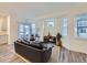 Comfortable living room features modern furniture, a sliding glass door, and sun-filled windows at 12920 Jasmine St # F, Thornton, CO 80602