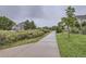 Community sidewalk lined with mature trees and landscaping, offering scenic walking and biking routes at 12920 Jasmine St # F, Thornton, CO 80602