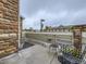 Private patio with outdoor seating, brick accents, and views of the surrounding community at 12920 Jasmine St # F, Thornton, CO 80602