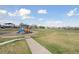Community playground featuring a colorful play structure with slide and ample green space at 12920 Jasmine St # F, Thornton, CO 80602