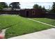 Large backyard featuring lush green grass and a brick structure, perfect for outdoor activities at 2902 Depew St, Wheat Ridge, CO 80214