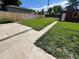Large, grassy backyard with wooden fence, concrete patio, and quaint shed at 2902 Depew St, Wheat Ridge, CO 80214