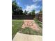 Backyard with stone patio, lawn, and wooden fence at 2902 Depew St, Wheat Ridge, CO 80214