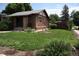 Charming brick home with lush landscaping and a well-manicured front yard at 2902 Depew St, Wheat Ridge, CO 80214