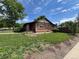 Charming brick home featuring a well-manicured lawn and mature trees at 2902 Depew St, Wheat Ridge, CO 80214