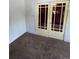 A hallway with french doors, neutral carpeting and white trim at 2902 Depew St, Wheat Ridge, CO 80214