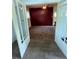 A hallway with french doors, neutral carpeting and white trim at 2902 Depew St, Wheat Ridge, CO 80214
