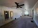 Spacious living room featuring a ceiling fan, neutral carpet, and natural light from the window at 2902 Depew St, Wheat Ridge, CO 80214
