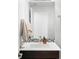 Bathroom vanity with a modern sink, large mirror, and neutral colored tile at 5134 Quitman St, Denver, CO 80212