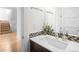 Stylish powder room featuring modern fixtures, mosaic tile accent, and hardwood floors at 5134 Quitman St, Denver, CO 80212