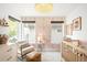 Bright Bedroom with patterned wallpaper, a rocking chair, and a crib at 5134 Quitman St, Denver, CO 80212