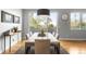 Dining room showcasing modern table under pendant lighting, with large windows offering picturesque outdoor views at 5134 Quitman St, Denver, CO 80212