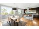 Dining area connecting to the kitchen, featuring a modern table and view of the outdoor living space at 5134 Quitman St, Denver, CO 80212