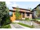 Landscaped front yard leading to a home with modern architectural details including angular rooflines and a mix of textures at 5134 Quitman St, Denver, CO 80212