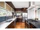 Gourmet kitchen featuring stainless steel appliances, custom cabinetry, and hardwood flooring at 5134 Quitman St, Denver, CO 80212