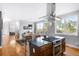 Open concept kitchen with a large island, stainless steel appliances, and hardwood floors at 5134 Quitman St, Denver, CO 80212
