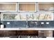 Modern kitchen features subway tile backsplash, stainless steel appliances, and window overlooking the backyard at 5134 Quitman St, Denver, CO 80212