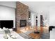 Inviting living area featuring a cozy fireplace, hardwood floors, and stylish furniture for a comfortable ambiance at 5134 Quitman St, Denver, CO 80212