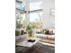 Bright living room featuring large windows with natural light, comfortable seating, and hardwood floors at 5134 Quitman St, Denver, CO 80212