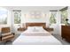 Stylish main bedroom with a headboard, large windows, and modern decor at 5134 Quitman St, Denver, CO 80212