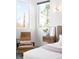 Comfortable main bedroom with natural light, accent chair, and stylish decor at 5134 Quitman St, Denver, CO 80212