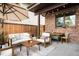Covered patio with brick exterior, outdoor seating, string lights and an umbrella at 5134 Quitman St, Denver, CO 80212