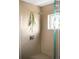A luxurious tiled shower with a rainfall shower head and botanical accents at 5134 Quitman St, Denver, CO 80212
