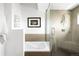 Bathroom featuring a glass shower with bench, bathtub, and rainfall shower head at 5134 Quitman St, Denver, CO 80212