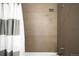 Shower area with gray tile and shower curtain at 5134 Quitman St, Denver, CO 80212
