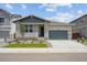Charming single-Gathering home with manicured lawn, gray accents, and attached two-car garage at 45933 Wood Thrush Ave, Bennett, CO 80102