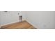 Clean laundry room area featuring light wood-look flooring and crisp white walls and electric outlets at 45933 Wood Thrush Ave, Bennett, CO 80102