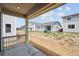 Covered patio of new construction home with view of backyard and neighboring houses at 45933 Wood Thrush Ave, Bennett, CO 80102
