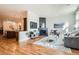 Open-concept living room with a modern fireplace, hardwood floors, and seamless flow to the adjacent kitchen at 1909 S Logan St, Denver, CO 80210