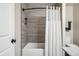 Modern bathroom with tub, shower, and sleek gray tile at 479 Josephine St, Denver, CO 80206