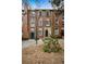 Charming brick townhome featuring blue shutters, a landscaped front yard, and a welcoming entrance at 479 Josephine St, Denver, CO 80206