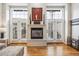 Elegant fireplace with white mantle, flanked by French doors, creating a warm and inviting focal point at 479 Josephine St, Denver, CO 80206