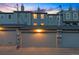 Exterior shot of gray multi-car garage behind townhomes at dusk at 479 Josephine St, Denver, CO 80206